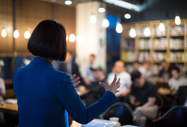 Woman speaking to a room of people